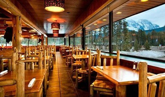 Timber-lined dining room with mountain view
