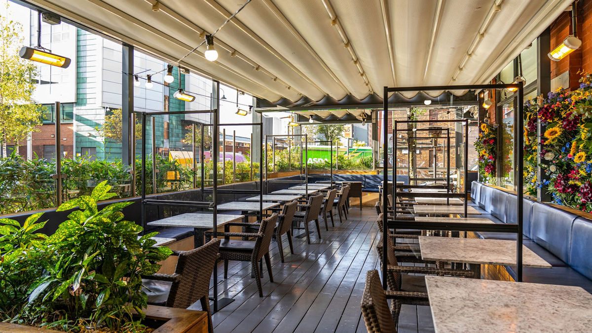 Restaurant terrace with planting and glass partitions
