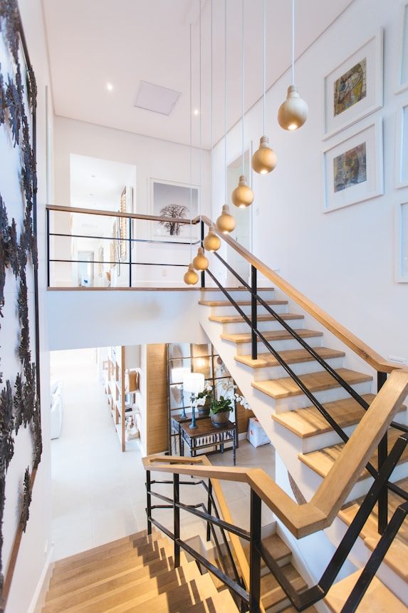 Staircase with brass pendant lighting