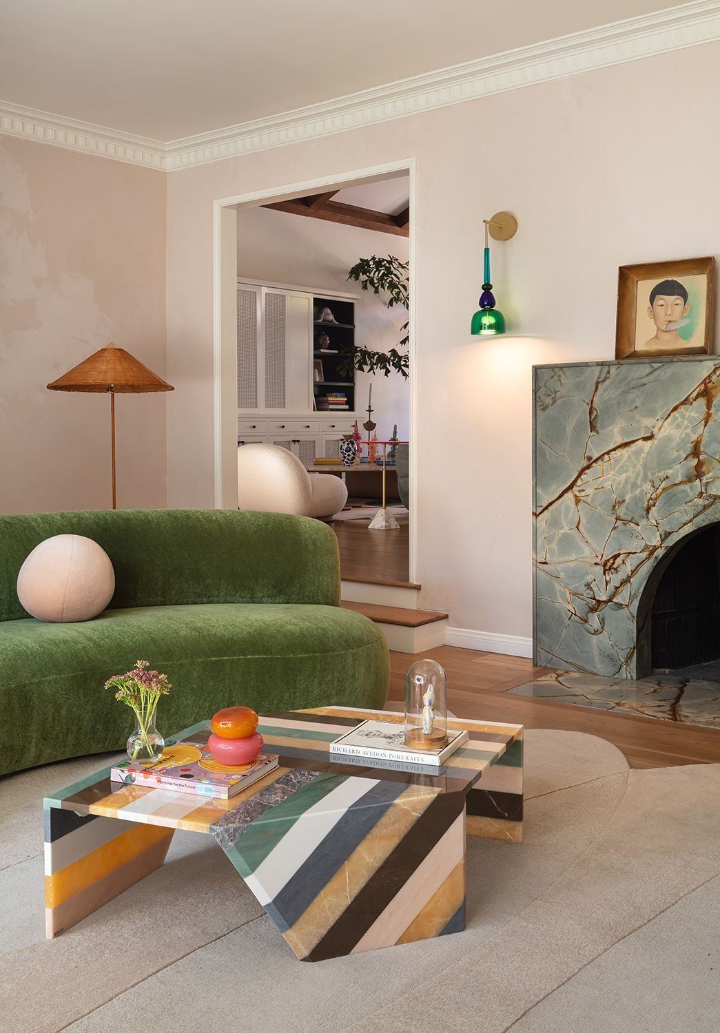 Living room with a green sofa and marble fireplace